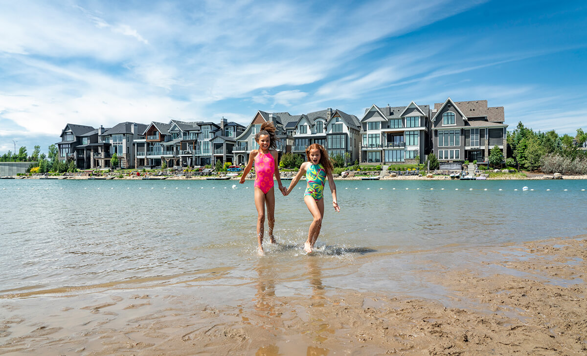 Two sisters holding hands while exiting the lake