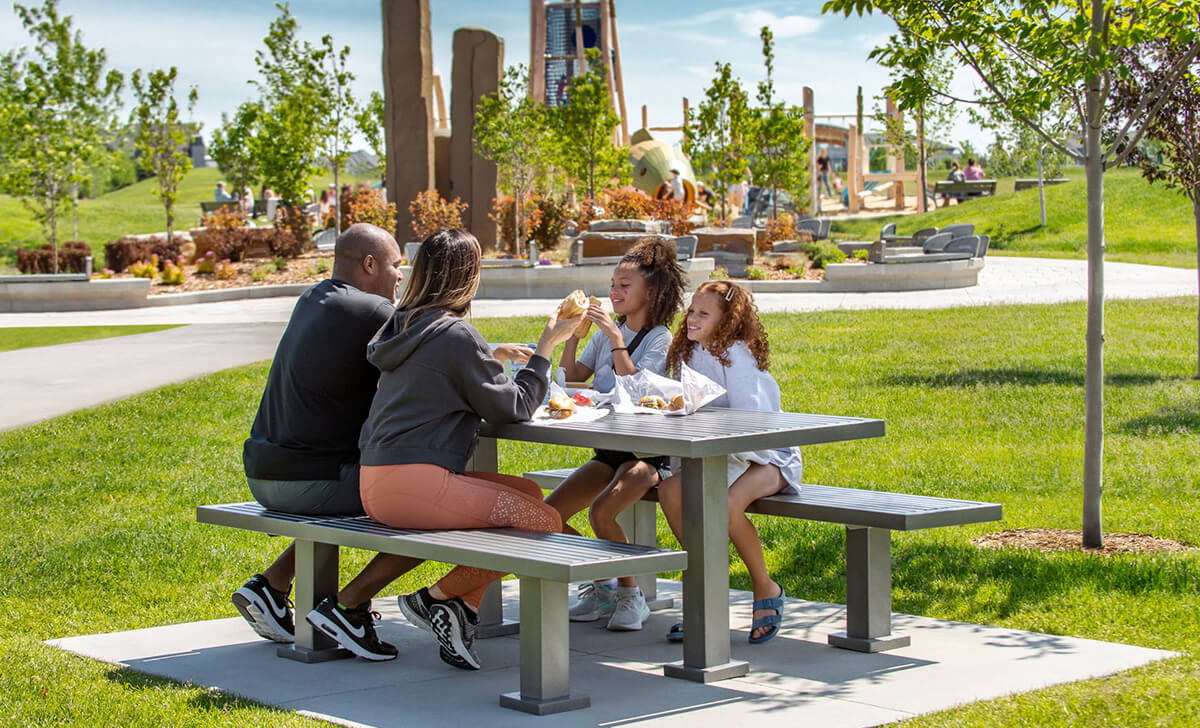 Family eating together on picnic table
